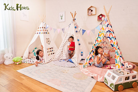 Three children with their teepees