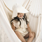 Child in white cream sun hat