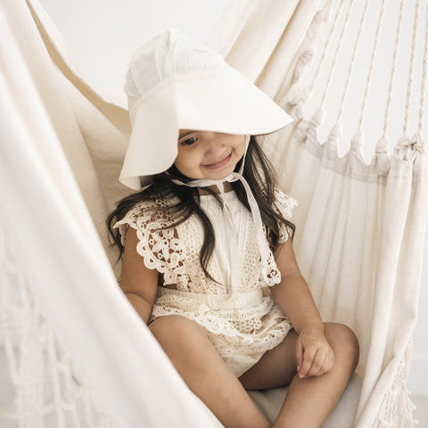 Child in white cream sun hat
