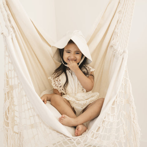 Child in white cream sun hat